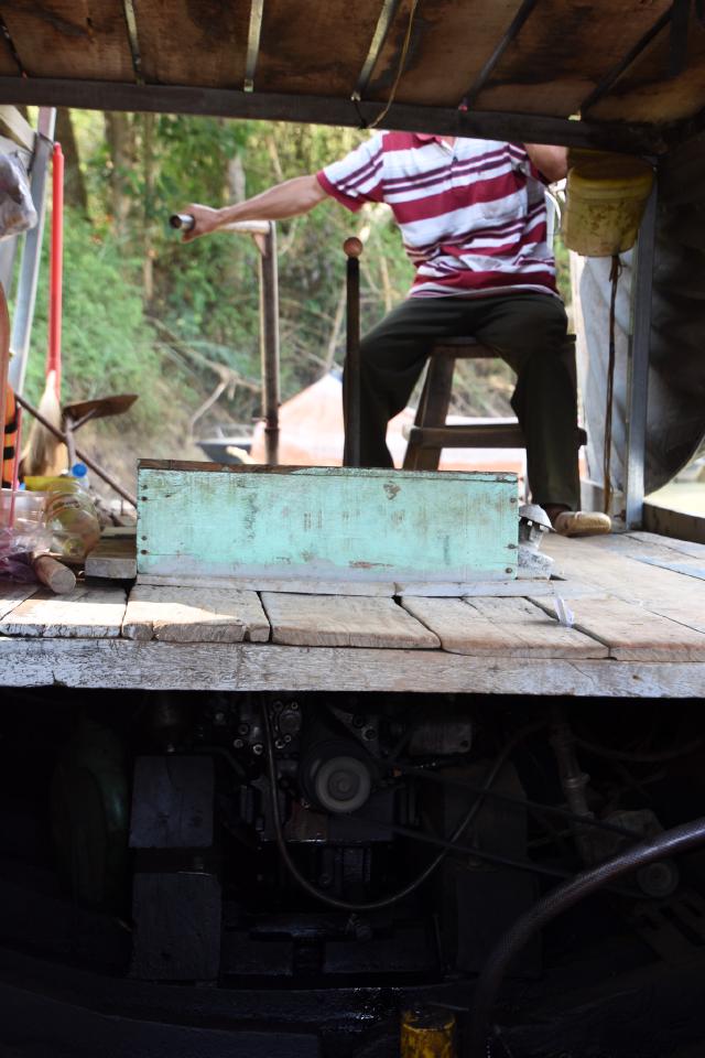 Ferry man, engine visible underneath